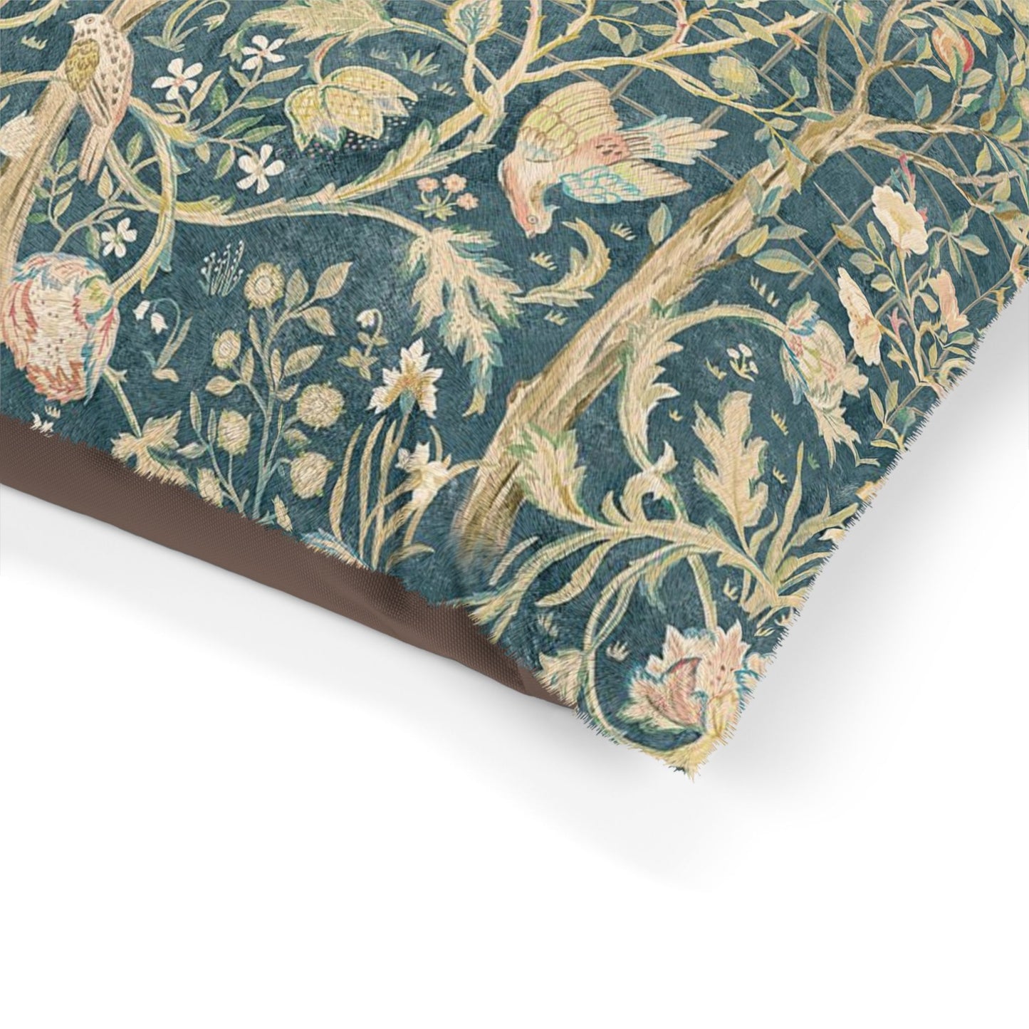 Decorative dog pillow with William Morris & Co floral and bird pattern on a white background