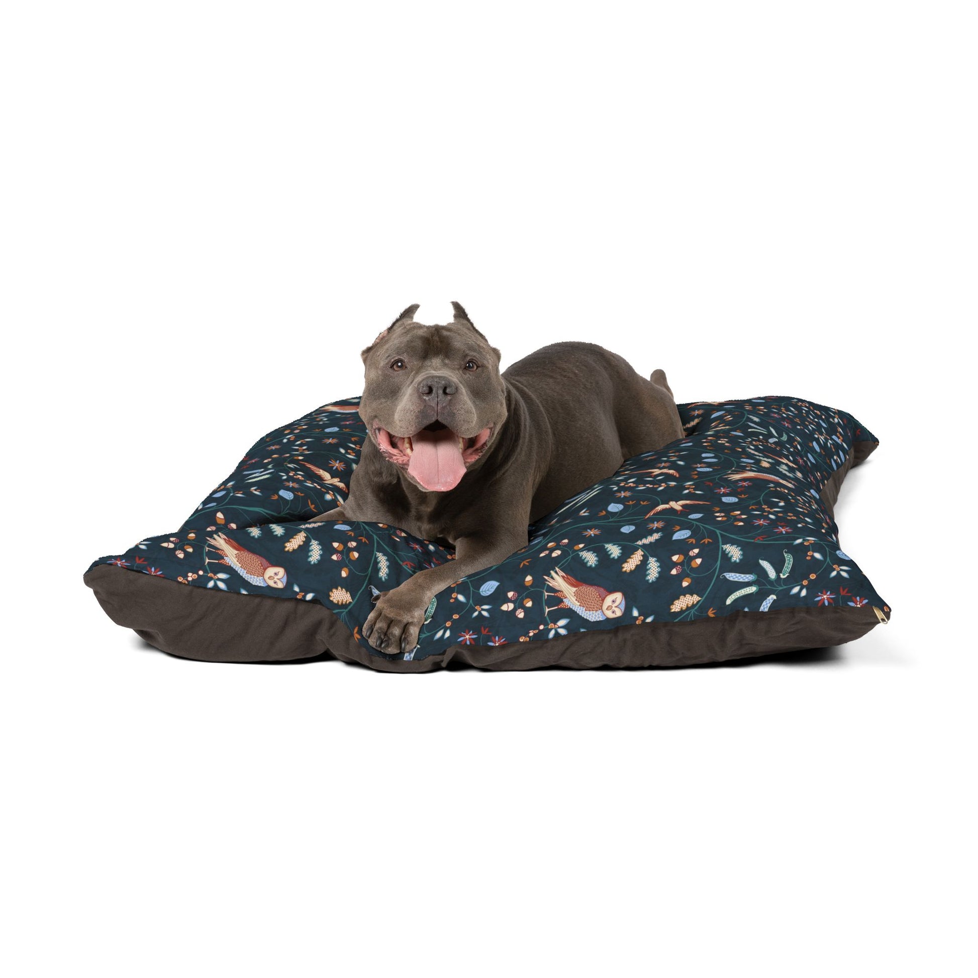 Dog lying on a floral-patterned pet bed with a white background
