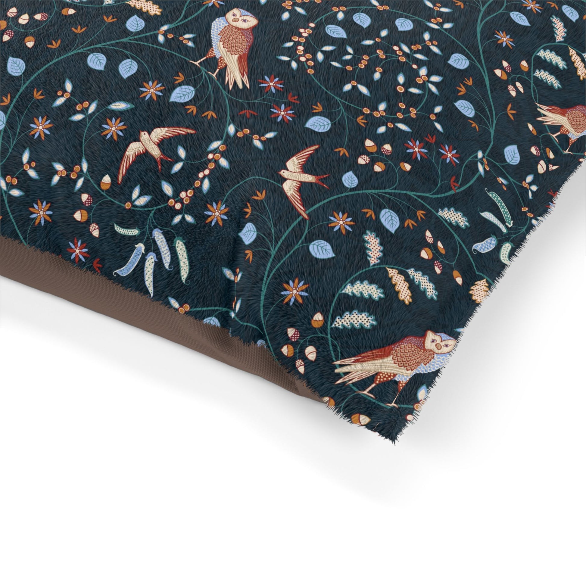 Embroidered fabric with birds and floral patterns on a dark blue background