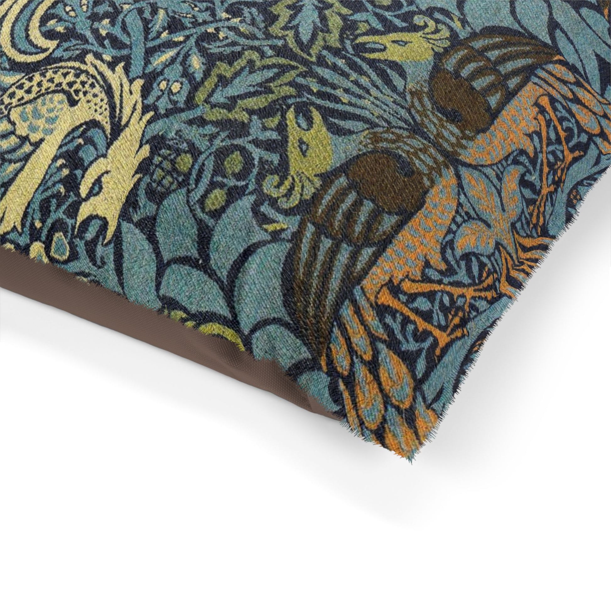 Decorative fabric with intricate patterns of birds and foliage on a teal background.