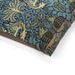 Close-up of a patterned fabric with birds and foliage on a white background