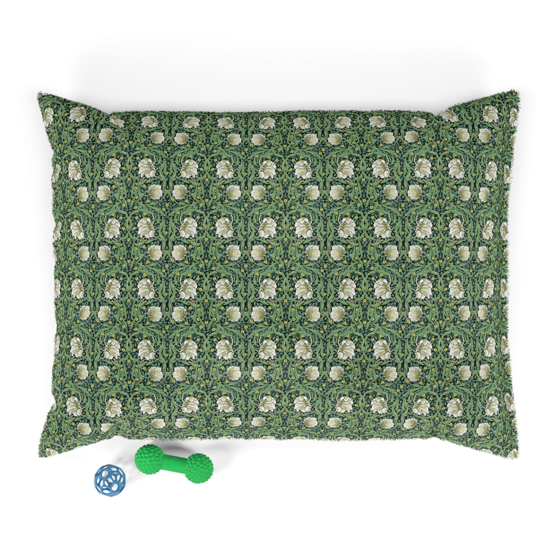 Green dog pillow with white floral pattern on a white background