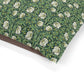 Floral patterned dog pillow with green leaves and white flowers on a white background