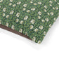 Floral patterned fabric with white flowers on a green background