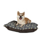 Dog sitting on a William Morris & Co floral-patterned dog bed with a white background