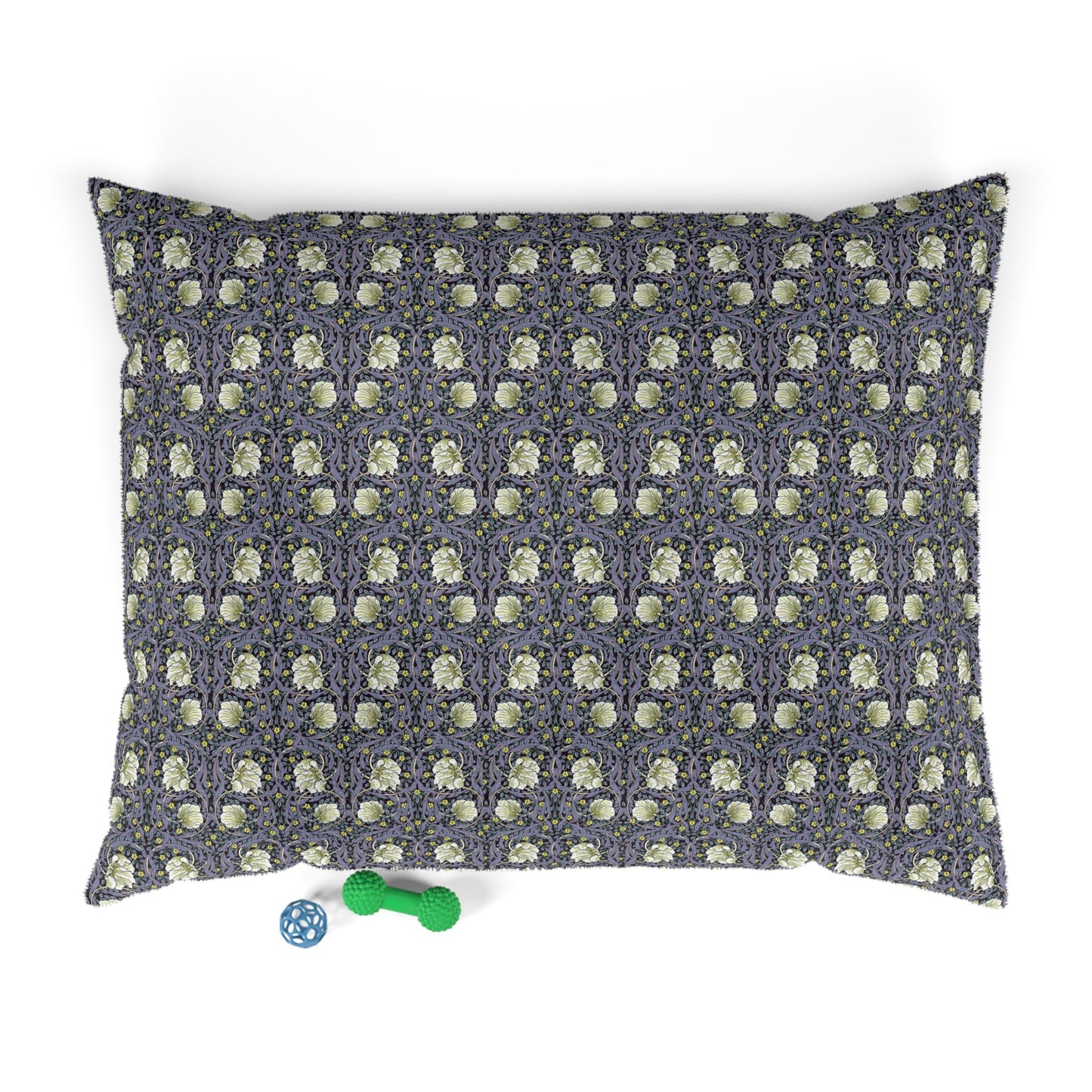 Floral patterned pet bed with two small toys on a white background