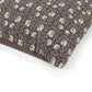 Floral patterned fabric with a brown border on a white background
