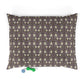 Patterned pillow with two dog toys on a white background