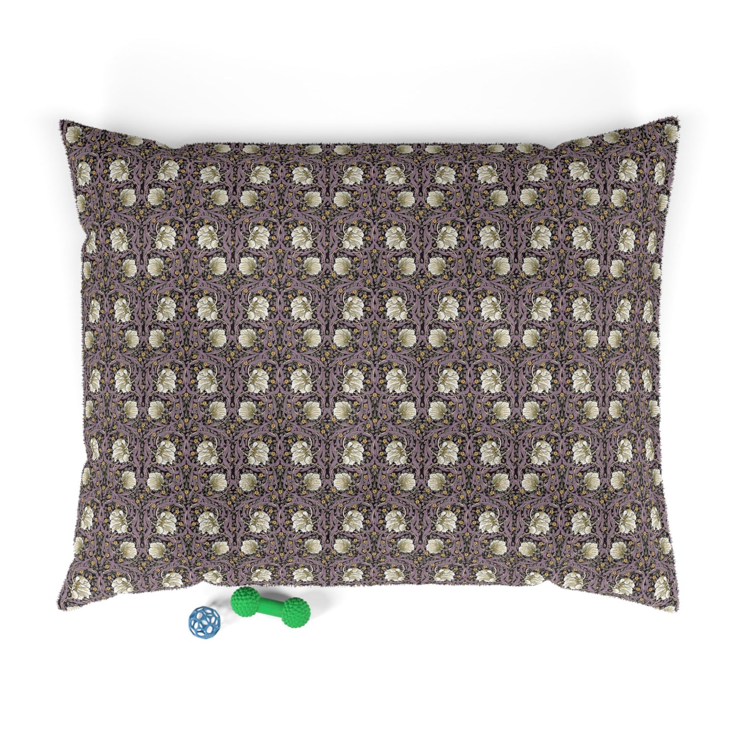 Patterned pillow with two dog toys on a white background