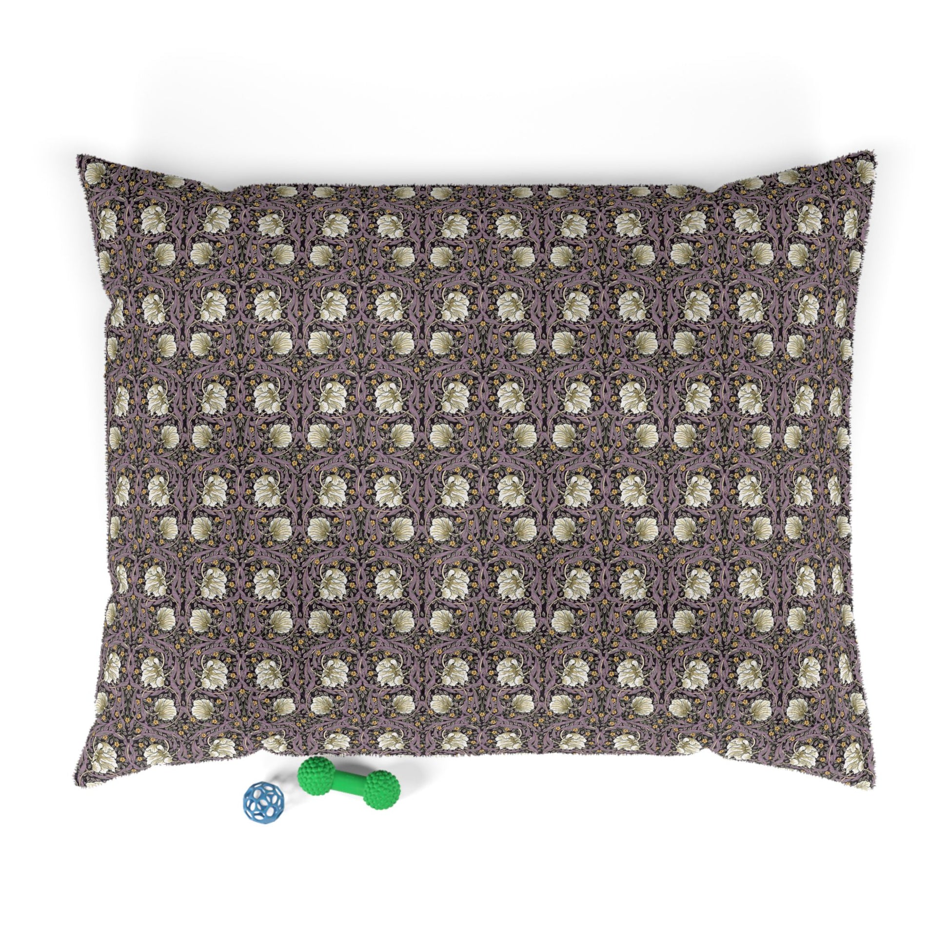 Patterned pillow with two dog toys on a white background
