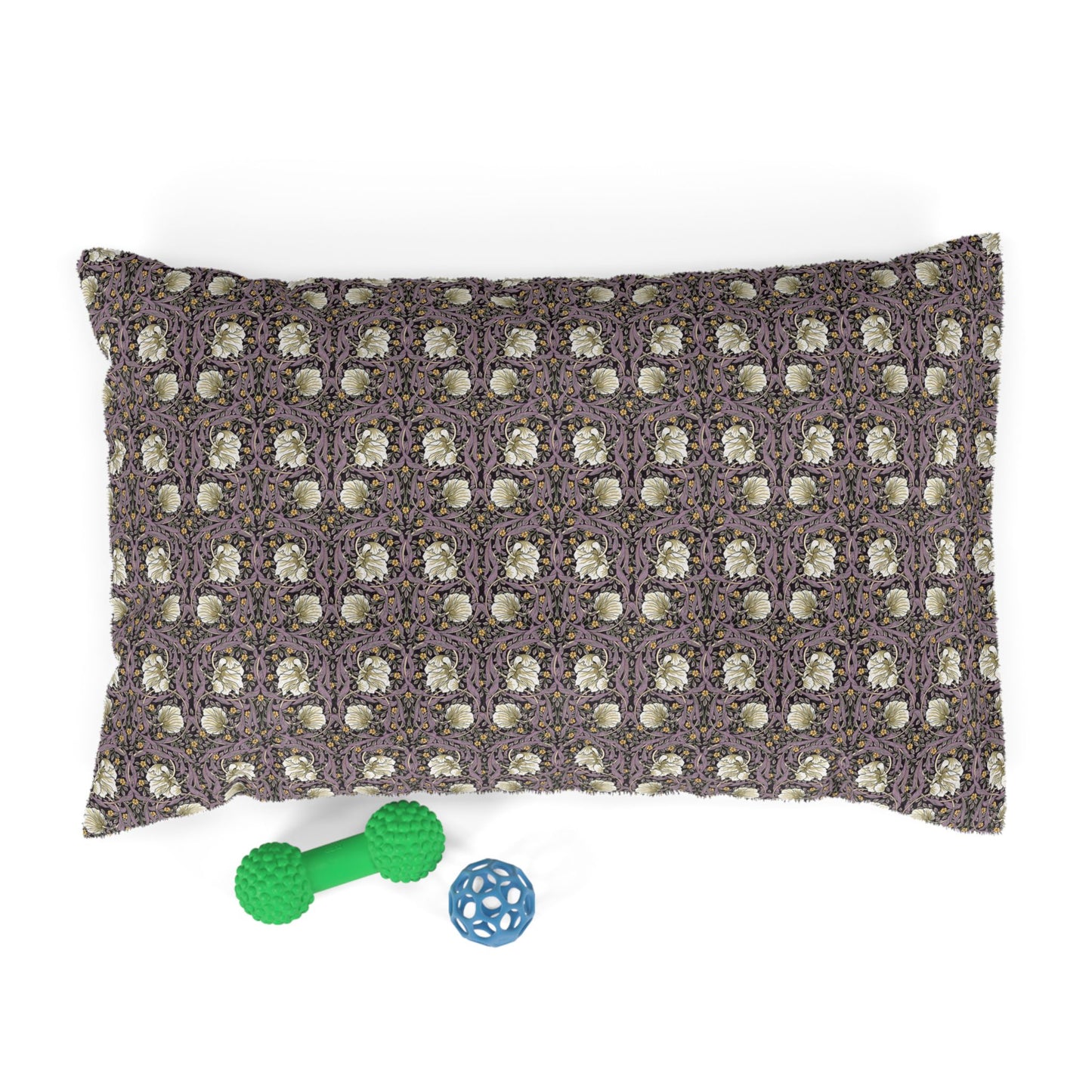 Patterned pillow with two dog toys on a white background