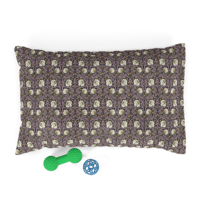 Patterned pillow with two dog toys on a white background