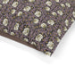 Floral patterned fabric with a brown border on a white background