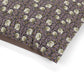 Floral patterned fabric with a purple background on a white surface