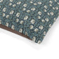 Floral patterned fabric with a brown border on a white background
