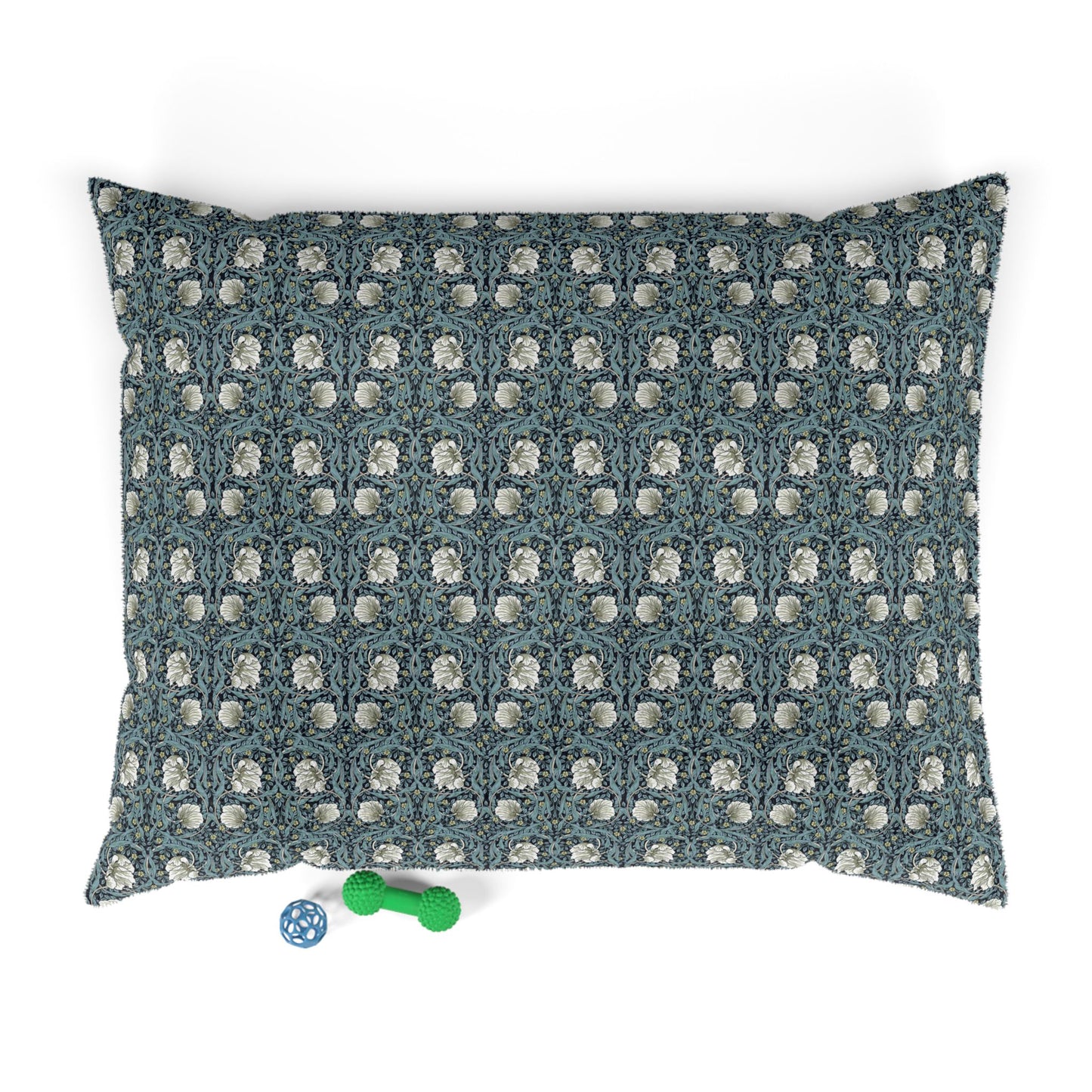 Floral patterned pet bed with two dog toys on a white background