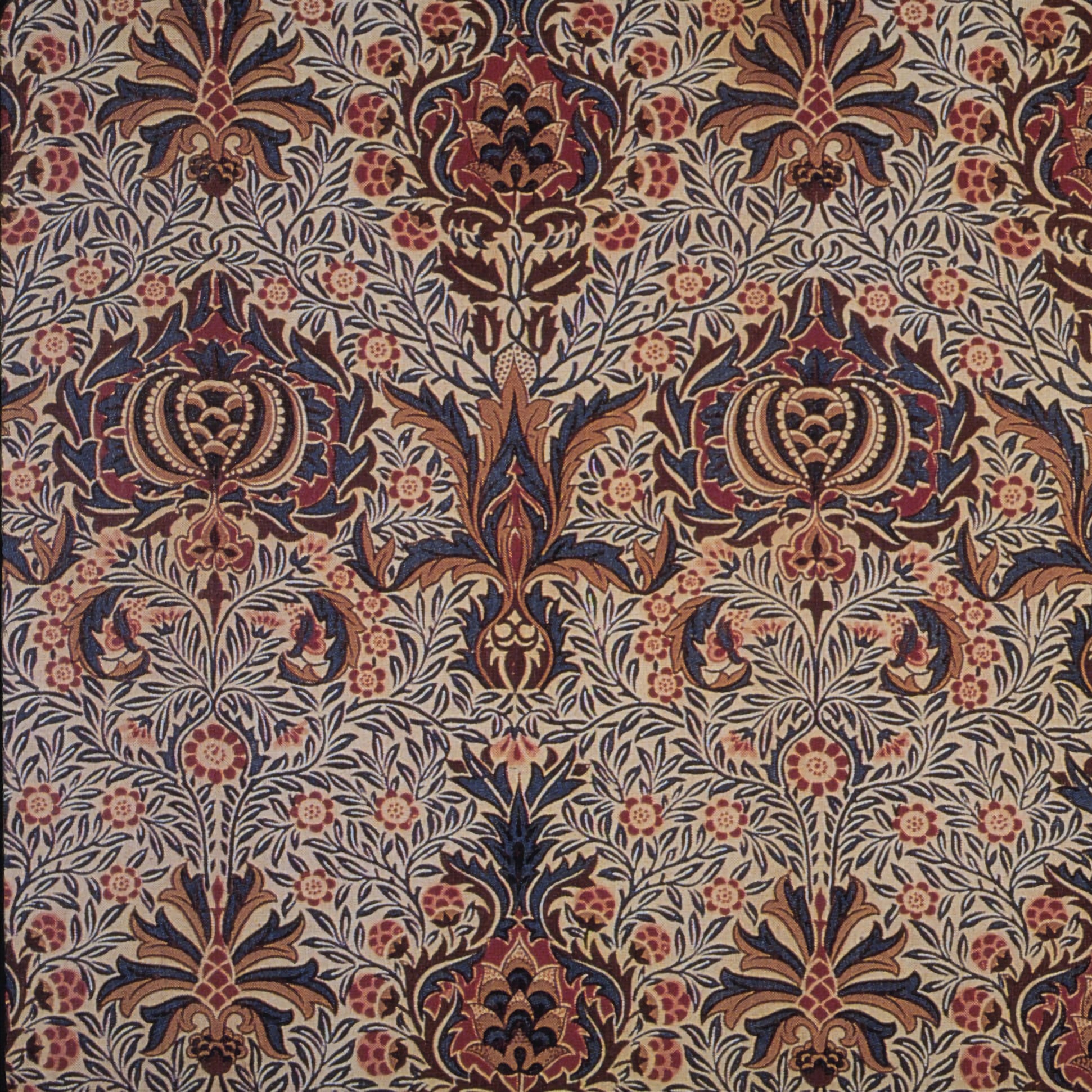 Decorative fabric pattern with intricate designs in brown, red, and beige.