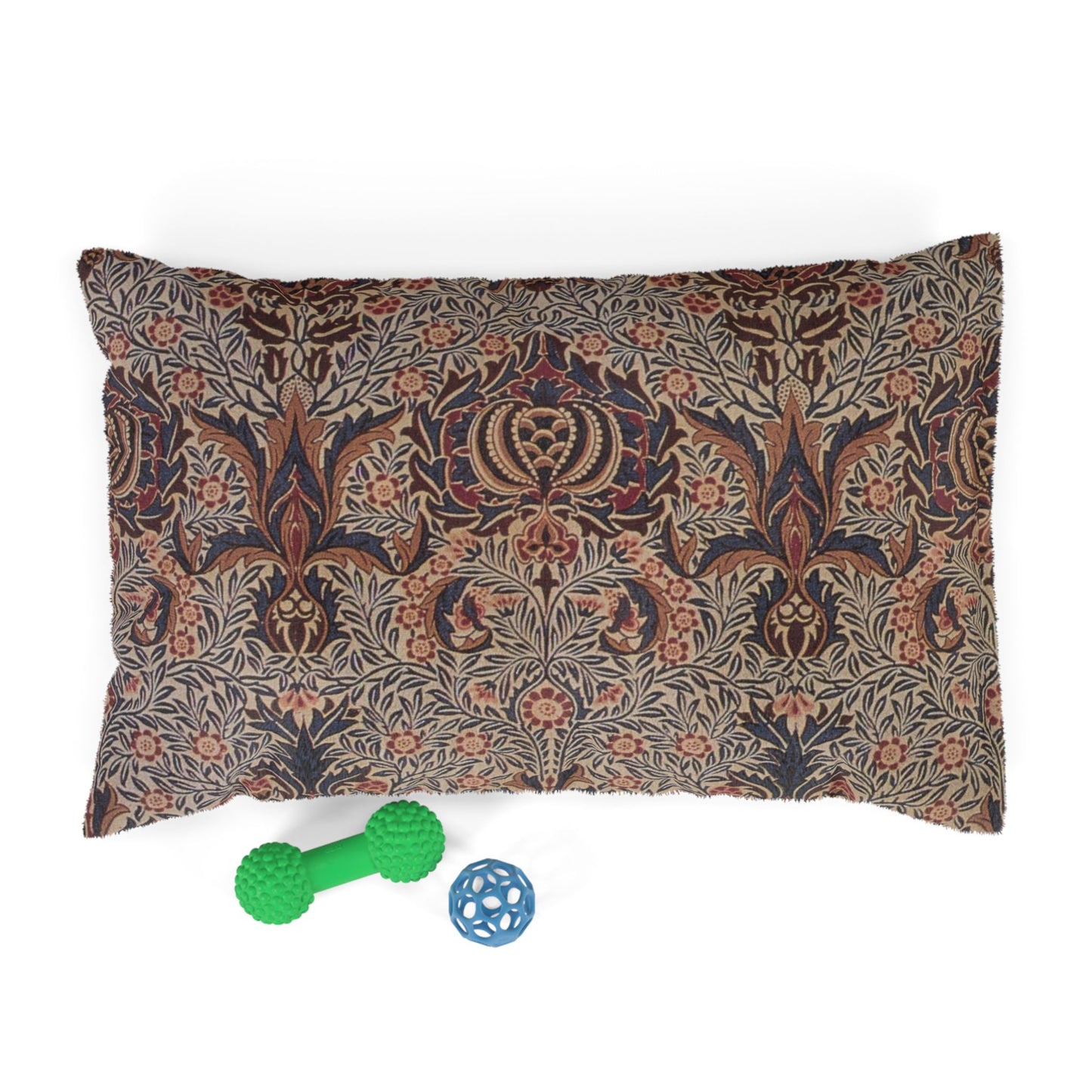 Decorative pillow with floral pattern and two dog toys on a white background
