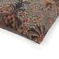 Close-up of patterned fabric with floral and leaf designs on a white background