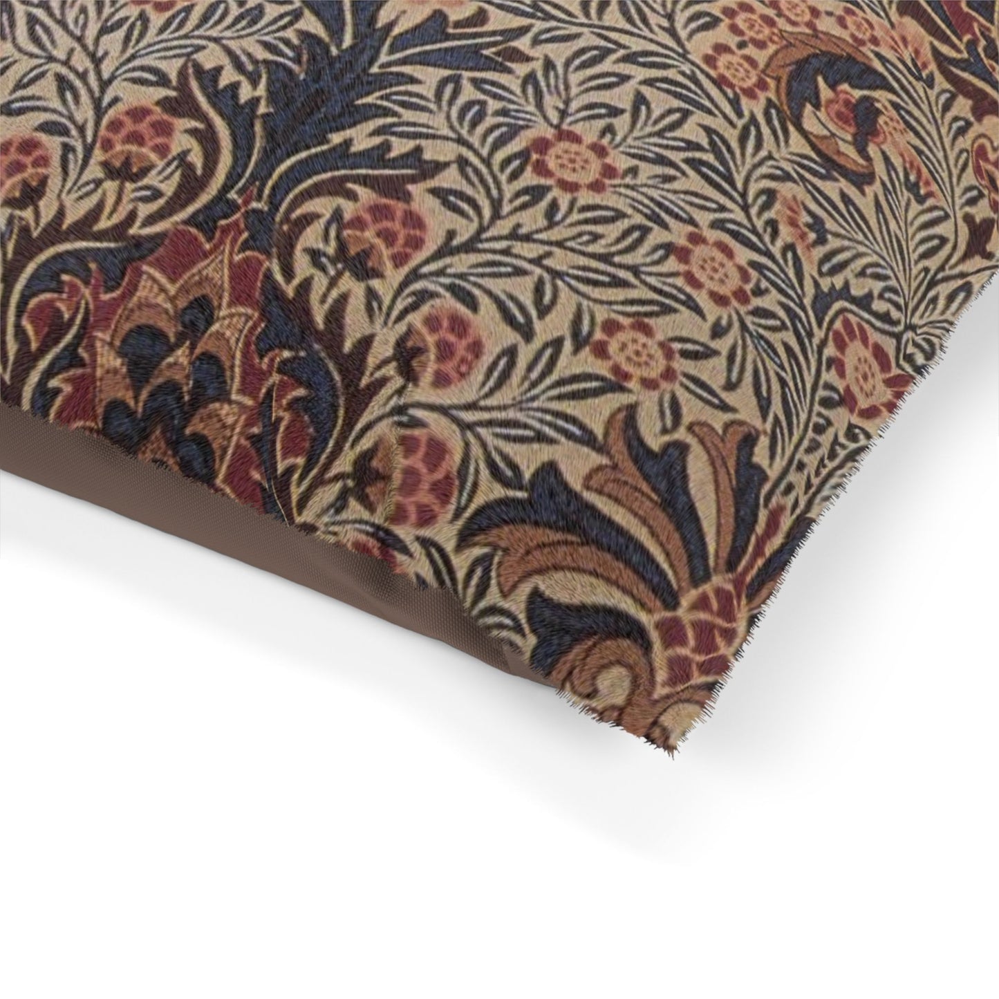 Close-up of patterned fabric with floral and leaf designs on a white background