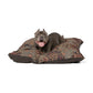 Dog lying on a patterned dog bed with a white background
