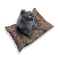 Dog sitting on a patterned dog bed with a white background