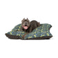 Dog lying on a William Morris & Co floral-patterned dog bed with a white background