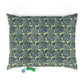 Floral patterned dog pillow with a small blue and green toy on a white background