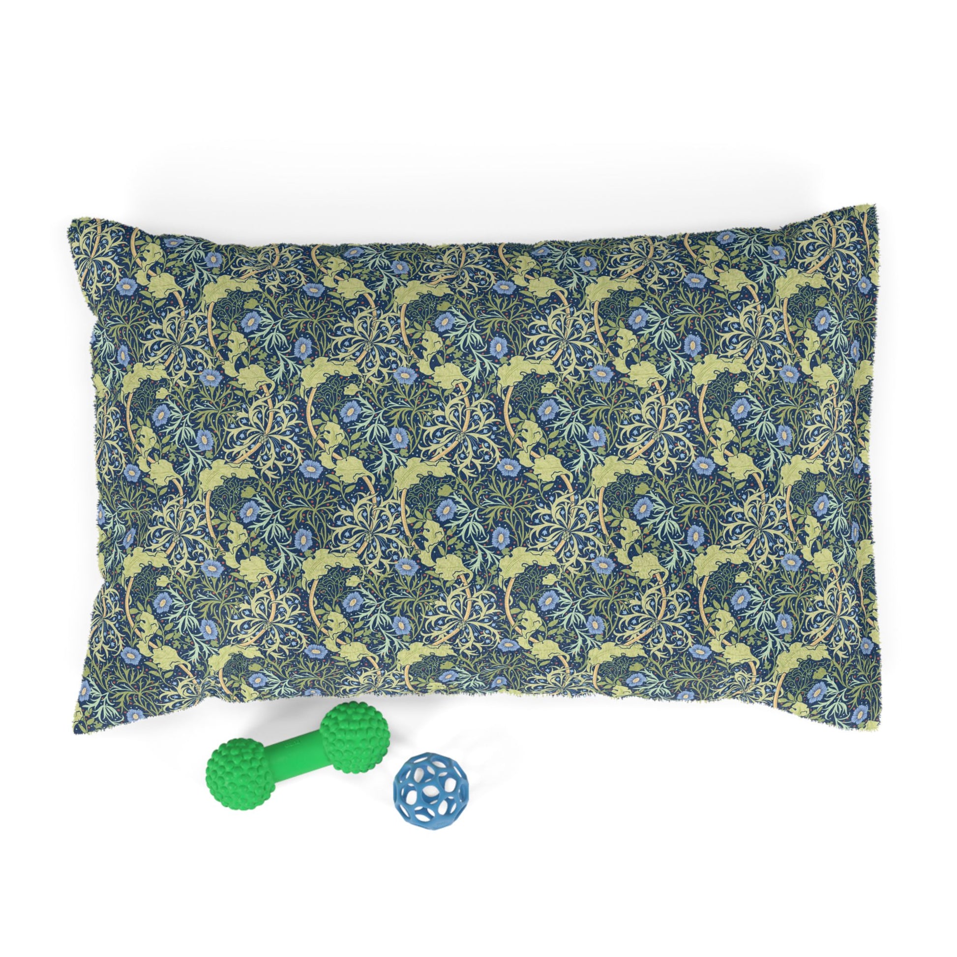 Floral patterned dog pillow with two dog toys on a white background