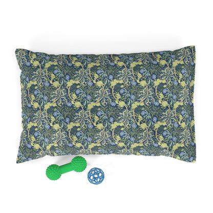 Floral patterned dog pillow with two dog toys on a white background