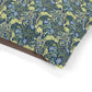 Floral patterned fabric with blue flowers and green leaves on a white background