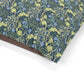 Floral patterned fabric with blue flowers and green leaves on a white background