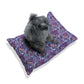 Dog sitting on a purple patterned dog bed against a white backgroundWilliam Morris & Co 