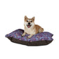 Dog lying on a floral-patterned pet bed with a white background