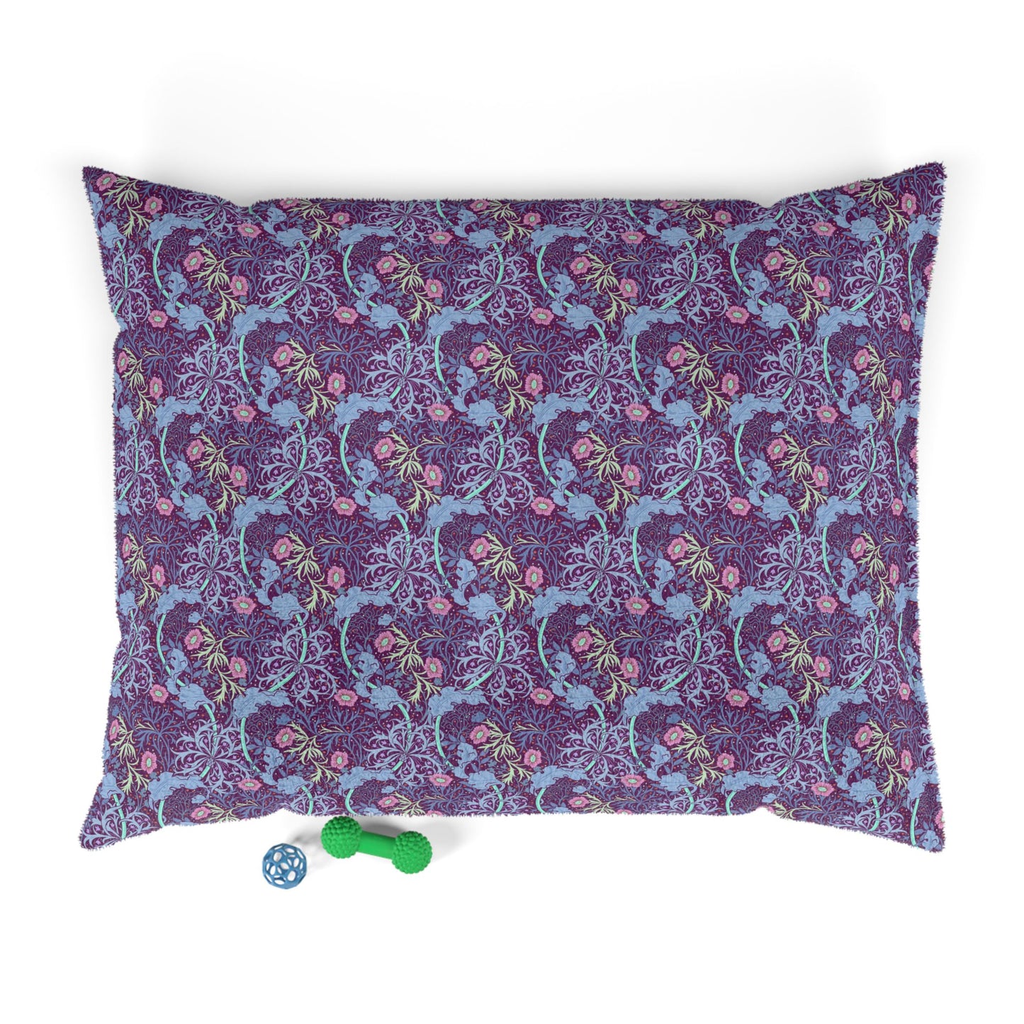 Floral William Morris & Co patterned dog pillow with a small green and blue toy on a white background