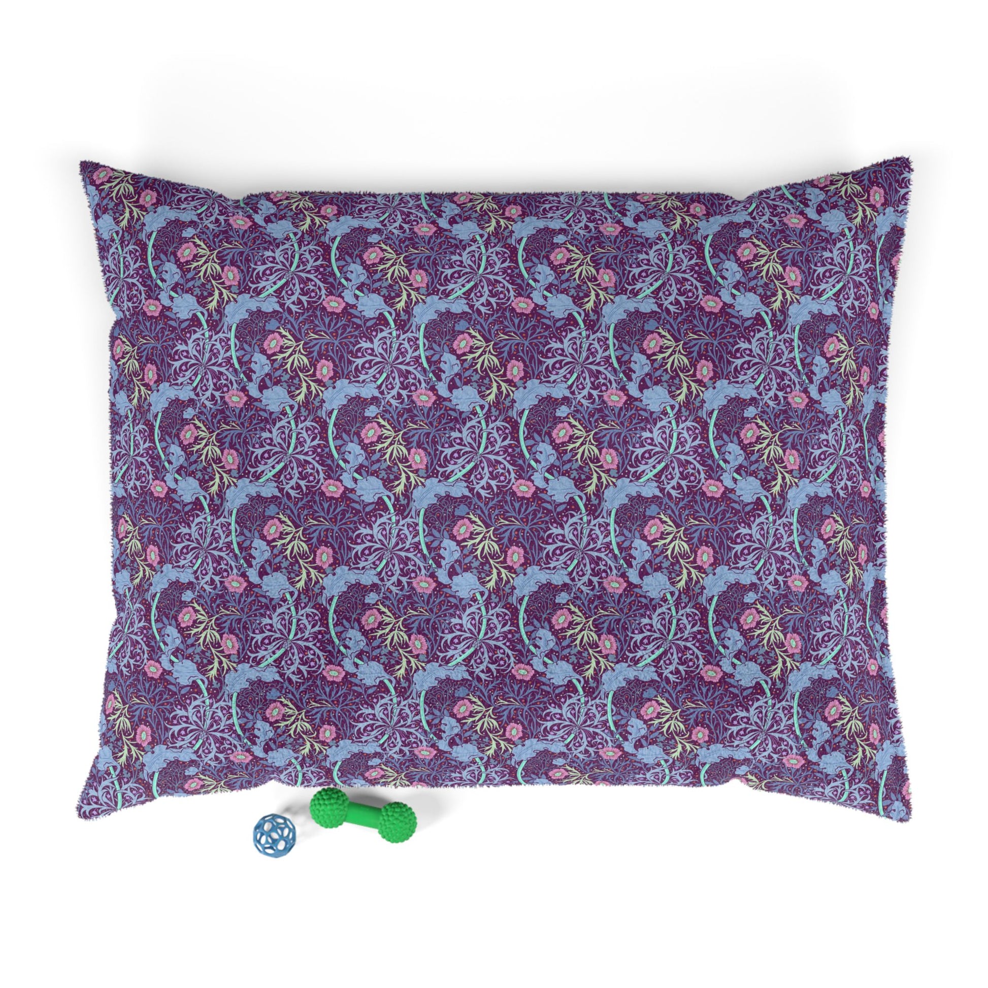 Floral William Morris & Co patterned dog pillow with a small green and blue toy on a white background
