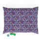 Floral-patterned dog pillow with a green and blue dog toy on a white background