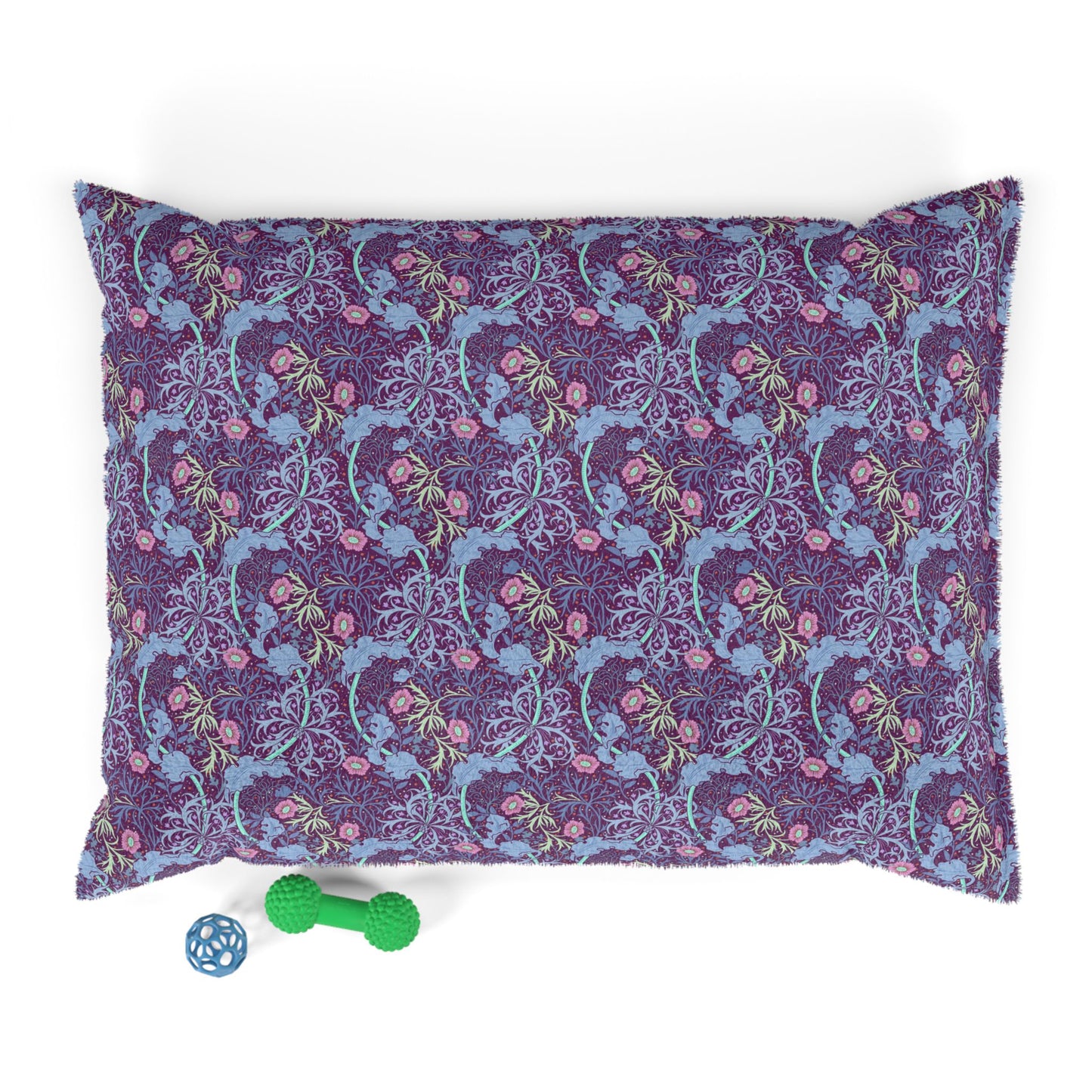 Floral-patterned dog pillow with a green and blue dog toy on a white background