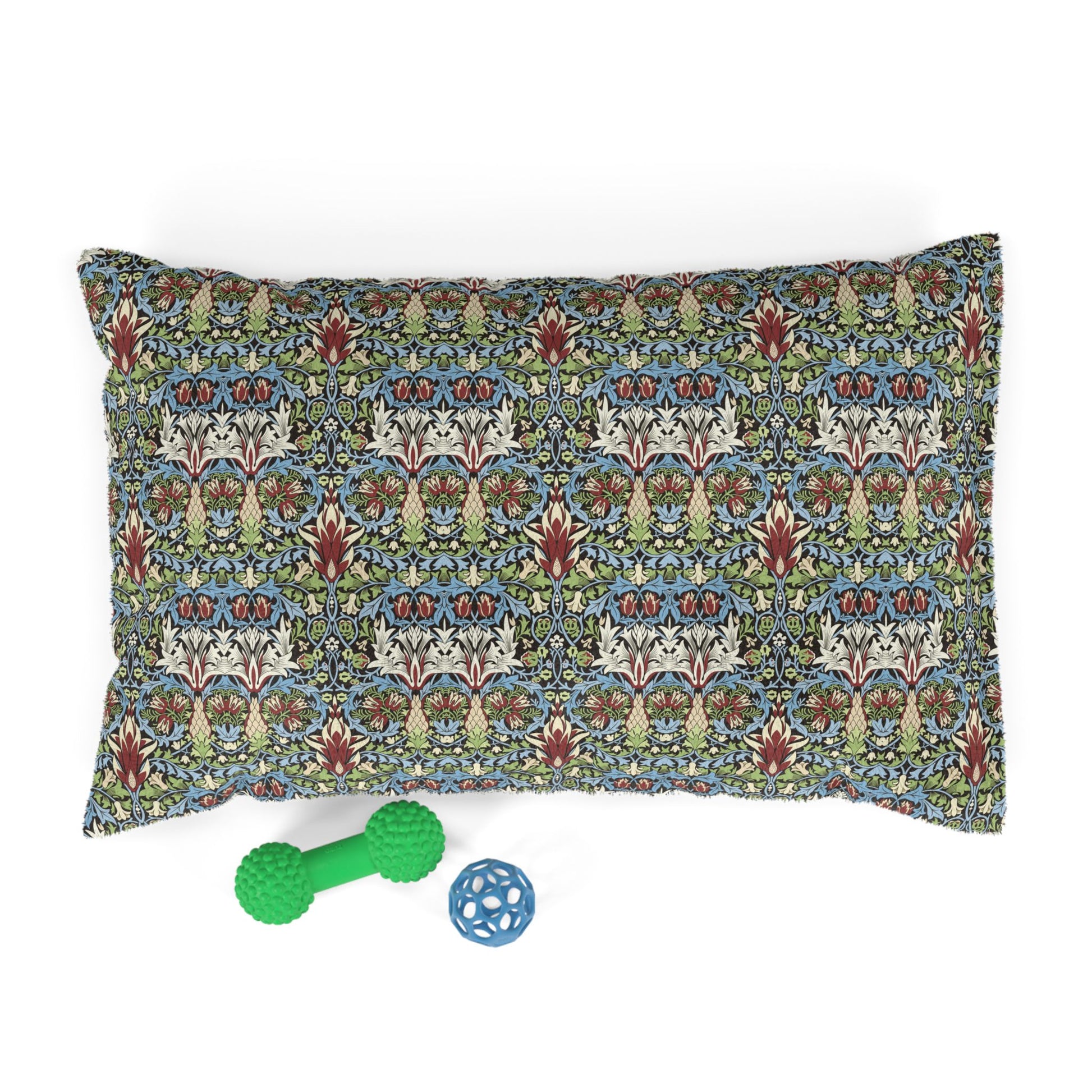 Decorative pillow with a patterned design on a white background, accompanied by two pet toys.