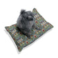 Dog sitting on a floral-patterned pet bed with a white background