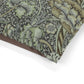 Close-up of a dog bed with intricate William Morris & Co green and brown pattern on a white background