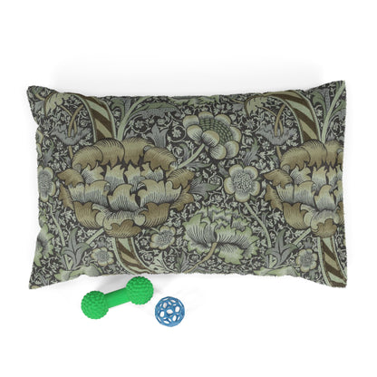 Decorative dog pillow with William Morris & Co floral pattern and two pet toys on a white background