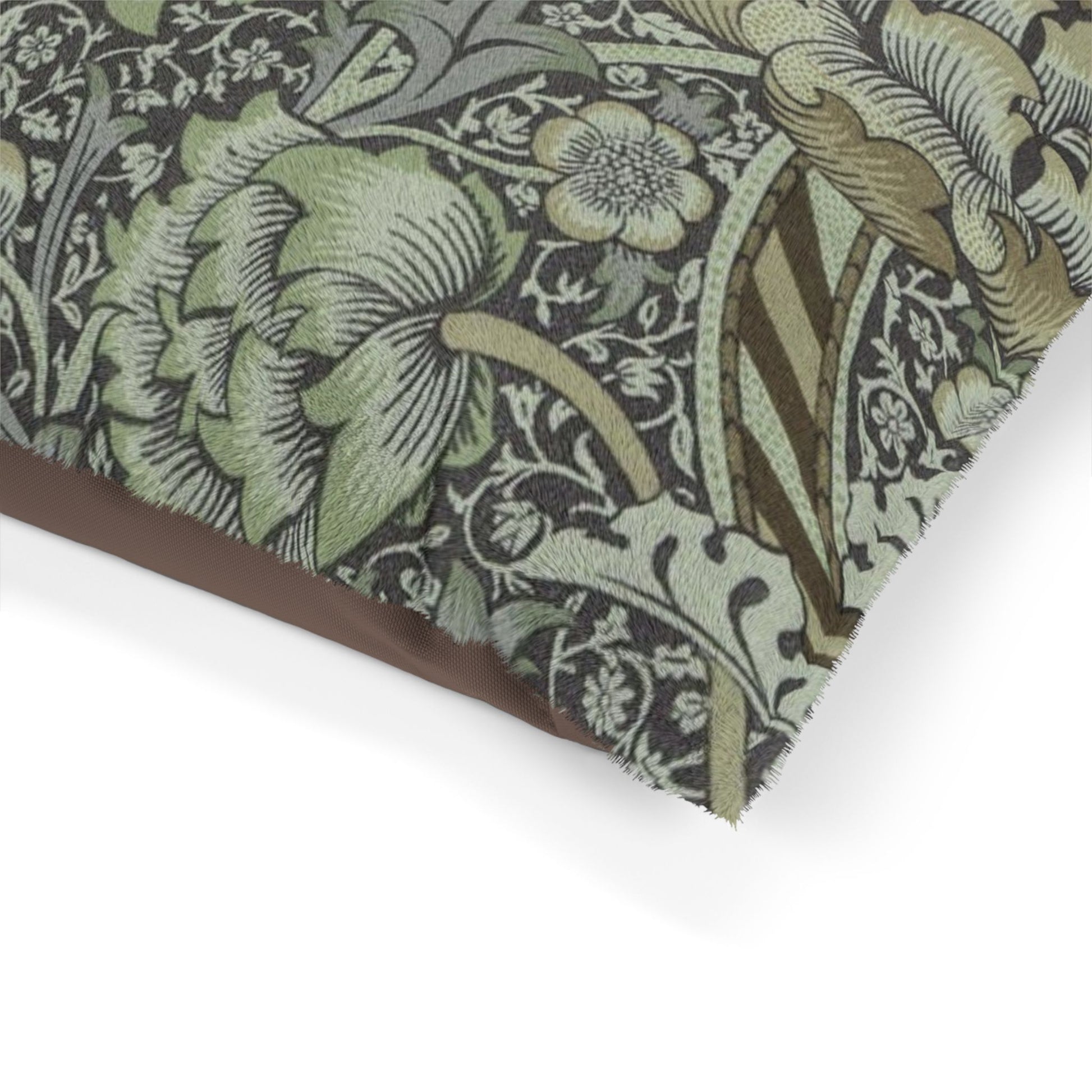 Close-up of a William Morris & Co floral patterned dog bed with green and brown colours on a white background