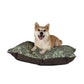 Dog sitting on a William Morris & Co patterned dog bed with a white background