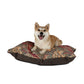 Dog sitting on a patterned pet bed with a white background