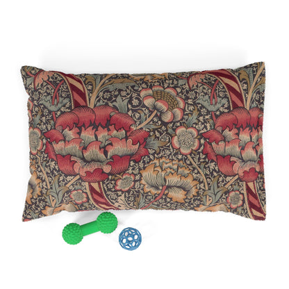 Decorative pillow with floral pattern and two pet toys on a white background