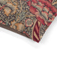 Close-up of a fabric with intricate floral and leaf patterns on a white background