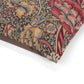 Close-up of a fabric with intricate floral and leaf pattern on a white background