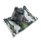 Dog sitting on a William Morris & Co decorative pillow with bird pattern