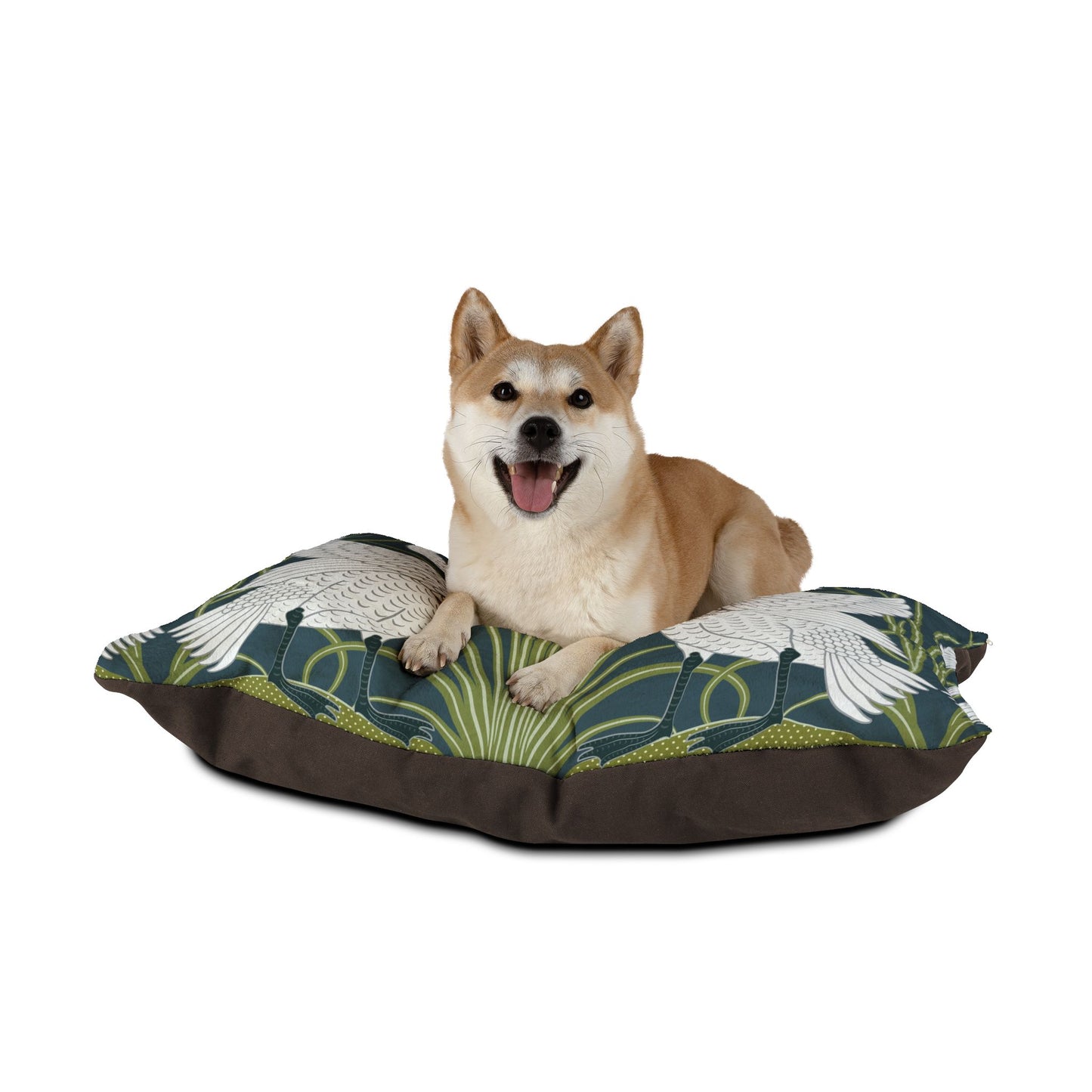 Dog sitting on a William Morris & Co floral-patterned pet bed with a white background